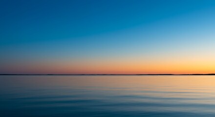Obraz premium Tranquil waterscape serene horizon with gradated sky at sunset