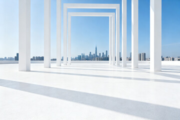 Modern white architectural frames overlooking a city skyline under a clear blue sky