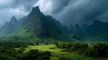 Obraz premium Moody Karst Mountains above Lush Green Valley and Bamboo