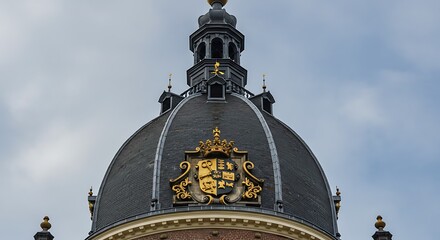 Ornate architectural dome exterior with gold accents against cloudy sky