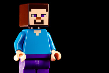 Naklejka premium LEGO Minecraft Steve stands on a black background
