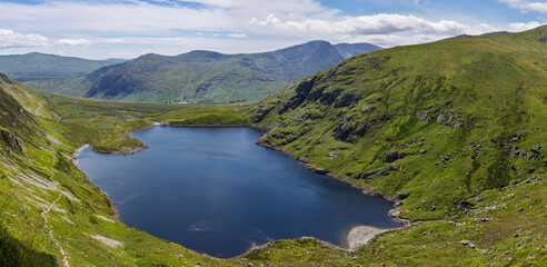 Fototapeta premium Ffynnon Llugwy reservoir below Carnedd Llewelyn, known as Carnedd Llywelyn, a mountain in the Carneddau range in Snowdonia National Park, officially known as Eryri National Park in northwest Wales, UK