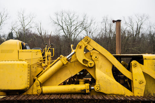 Closeup of a yellow bulldozer in a field in winter in the midwest