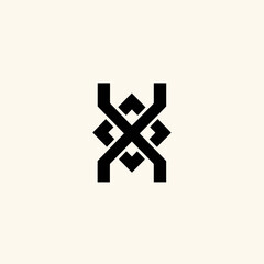 Obraz premium A symmetrical black design featuring interlocking shapes, arranged on a light background