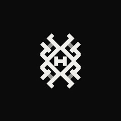 Geometric design with the letter H, incorporating a complex pattern in white and gray on a black background