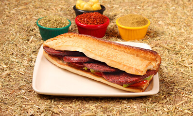 a delicious sandwich with sausage, vegetables