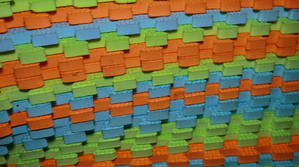 Colorful foam mats interlock creating a textured surface with vibrant hues in a playful and engaging pattern perfect for children's play areas.