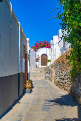 Beautiful narrow alley and whitewashed walls of Lindos, Rhodes, Greece