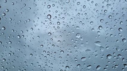 Raindrops on glass close-up. Black and white monochrome. Selective focus