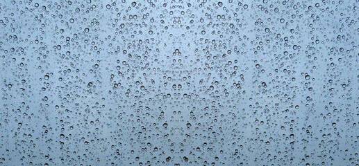 Raindrops on glass close-up. Black and white monochrome. Selective focus