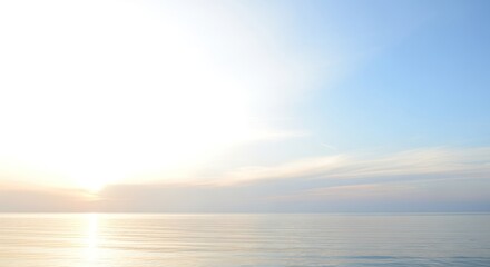Obraz premium Calm ocean scene with pastel blue sky at golden sunrise or sunset