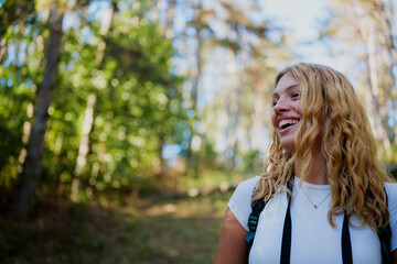Woman hiking in forest experiencing joy and freedom
