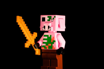 Obraz premium LEGO Minecraft Zombie Pigman with a golden sword stands in the dark