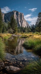 Majestic granite cliffs reflected in a tranquil mountain stream, showcasing a serene natural scene.