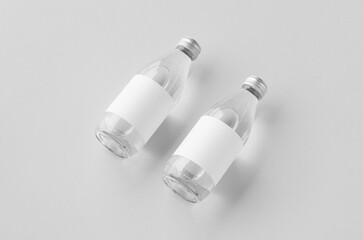 Small water bottle mockup with blank label, clear glass