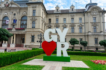 I Love Gyor sign in front of City Hall, Hungary, historic architecture background