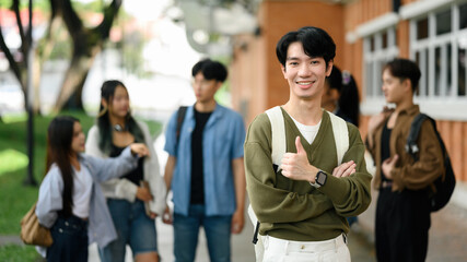 Young Asian student standing proudly with thumbs up, symbolizing confidence, inclusivity, and belonging in diverse university life