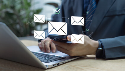 Businessman using laptop send email to customers with email icon representing business communication digital marketing, newsletters, and online networking for customer engagement and corporate contact