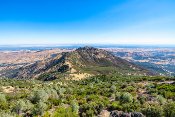 Scenic panorama from Mount Diablo summit in California showing rolling hills, dry golden slopes,...
