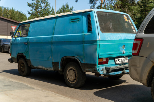 Russia, Sosnovy Bor, July 19, 2025 -Light blue volkswagen t3 van, Old weathered blue volkswagen van parked on street