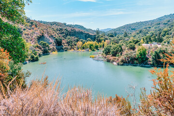 Lake Ranch Reservoir in Sierra Azul Open Space Preserve near San Jose, California, USA. Scenic green water lake surrounded by lush forested hills, a hidden gem for hikers and nature lovers