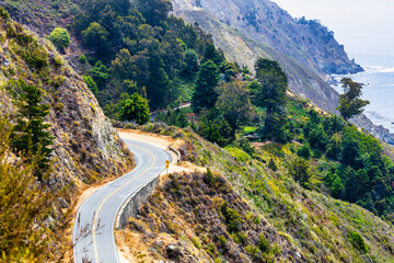 Scenic winding road along Highway 1 in Big Sur, California USA, with dramatic coastal cliffs and Pacific Ocean view, iconic travel and road trip destination on the Pacific Coast Highway