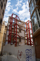 Urban construction site with red steel supports