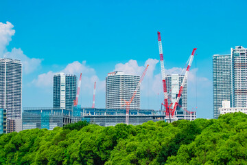 A cityscape of crane at the under construction in the business town telephoto shot