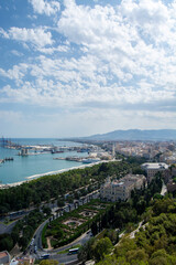 Obraz premium Coastal cityscape with harbor and greenery under blue sky