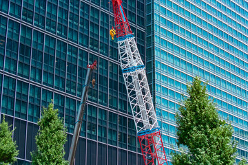 A cityscape of crane at the under construction in the business town telephoto shot