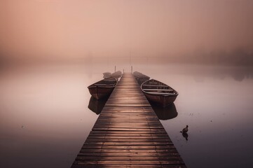 Boats docked beside a wooden jetty