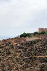 Fototapeta premium Historic castle wall overlooking coastal landscape