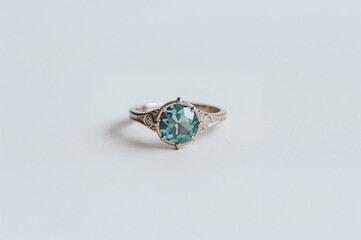 Light-colored background featuring an aquamarine gemstone ring