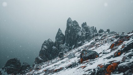 Stunning winter snow blankets towering peaks with jagged rocks on the slopes.