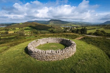 Bird's-eye perspective of an ancient circular fort and well-known travel destination along a scenic coastal route