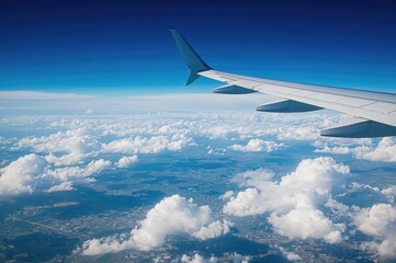 Fototapeta premium View from above showing airplane wing against clear blue sky