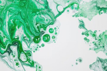 Acrylic paint splash with random brush marks, green hues spreading on a white sheet. Artistic fluid texture background.