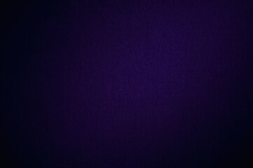 Fototapeta premium Close-up of blue textured fabric against a dark purple checkered backdrop