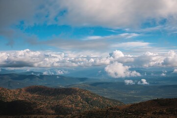 Fototapeta premium Sky filled with clouds above a picturesque terrain