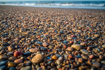 Obraz premium Detailed View of Moist Sand Featuring Vibrant Stones