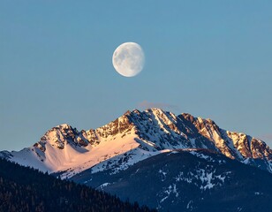 Full moon over snow-capped mountains at dawn