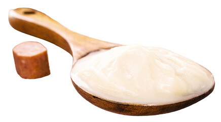 spoon of pork fat, lard used as a culinary ingredient in Brazil, pork meat in the background