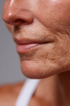 A close-up of a mature face with wrinkles