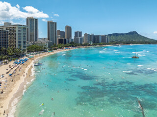 Aerial view of sun-kissed sands meet the turquoise sea, framed by Waikiki's skyline and the majestic Diamond Head, Honolulu, Hawaii, United States.