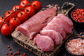 Raw pork tenderloin, sliced, is fresh meat, a source of protein. Pork tenderloin