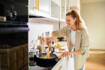 Woman cooking in modern kitchen