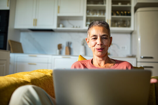 Senior woman using laptop at home