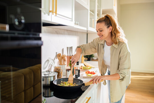 Woman cooking in modern kitchen