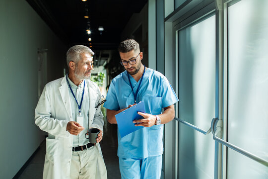 Healthcare professionals discussing while walking in a hospital hallway