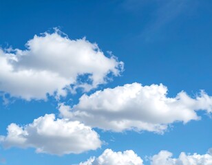 Obraz premium Fluffy white clouds against a vibrant blue sky